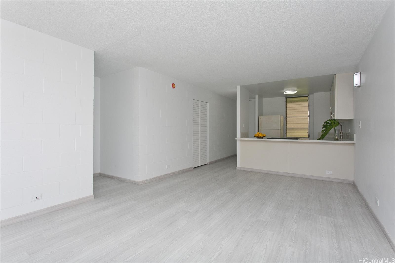 5122 Likini Street, Unit 214 Honolulu, HI 96818 - Photo 3 of 11 an empty room with a kitchen and a sink