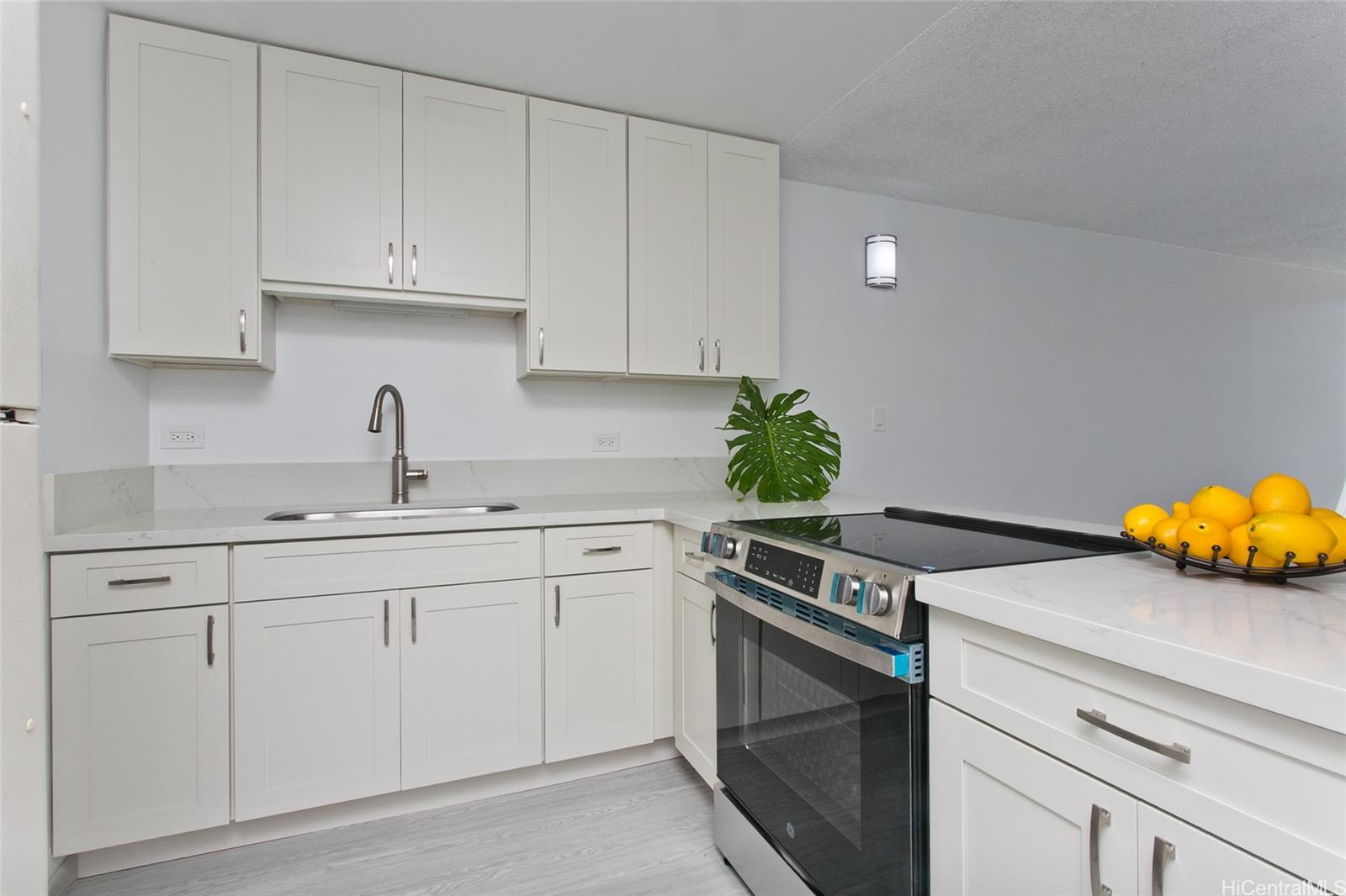 5122 Likini Street, Unit 214 Honolulu, HI 96818 - Photo 4 of 11 a kitchen with appliances a sink and cabinets