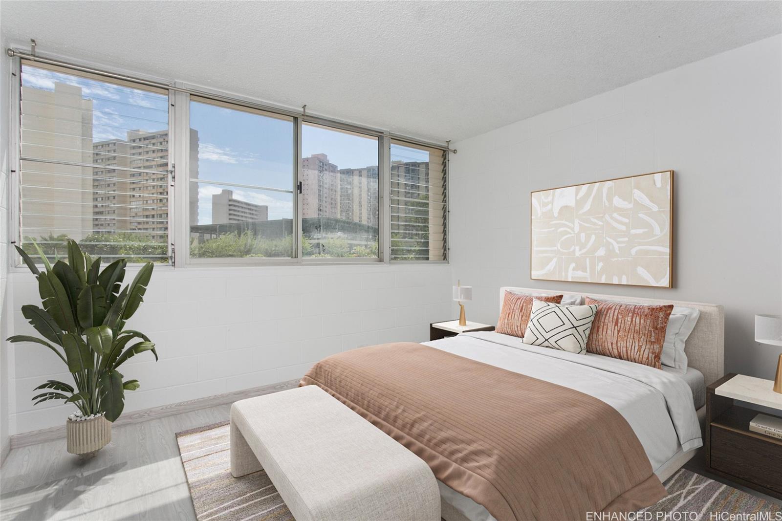 5122 Likini Street, Unit 214 Honolulu, HI 96818 - Photo 6 of 11 a bedroom with a large bed and a large window