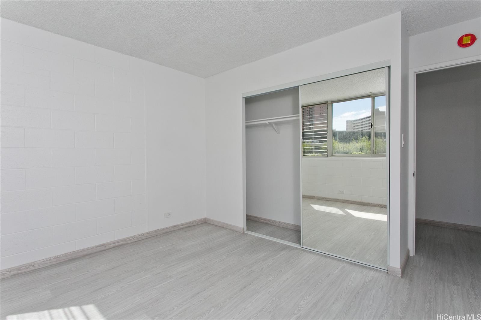 5122 Likini Street, Unit 214 Honolulu, HI 96818 - Photo 8 of 11 an empty room with windows