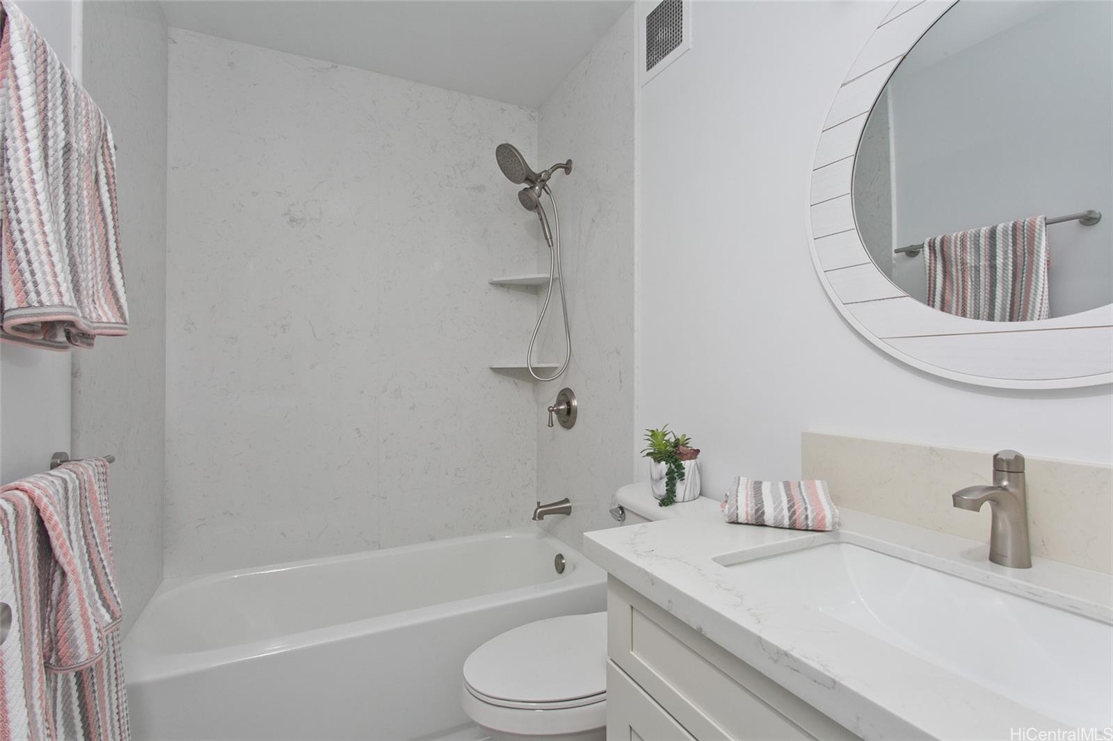 5122 Likini Street, Unit 214 Honolulu, HI 96818 - Photo 9 of 11 a bathroom with a sink toilet and shower