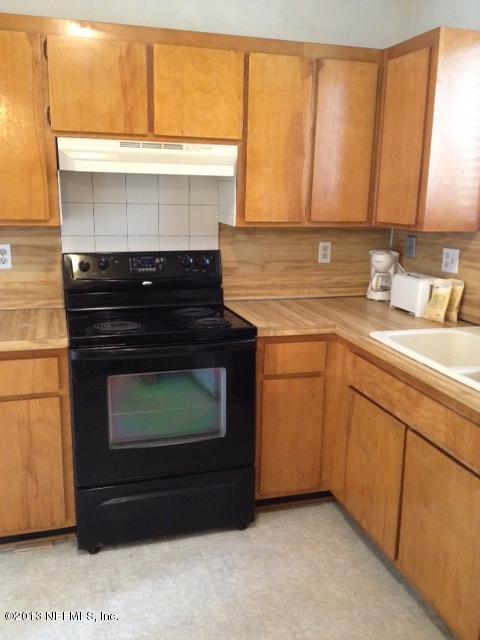 2094 Cornell Road Middleburg, FL 32068 - Photo 8 of 9 a stove top oven sitting inside of a kitchen