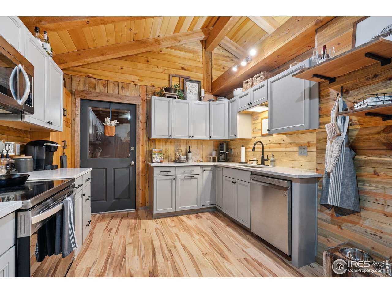 32224 Poudre Canyon Road Bellvue, CO 80512 - Photo 11 of 34 a kitchen with granite countertop a sink cabinets stainless steel appliances and a counter top space