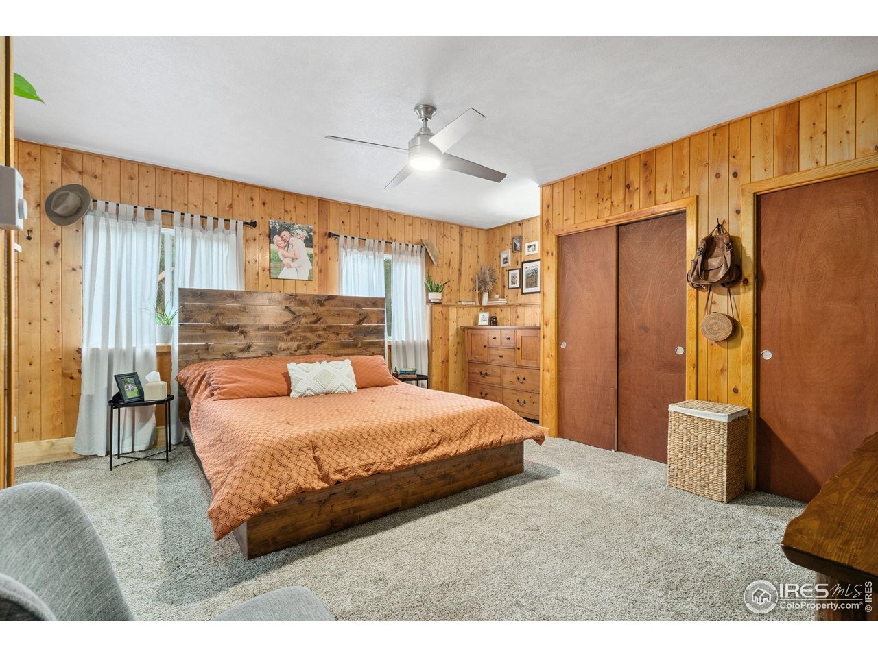 32224 Poudre Canyon Road Bellvue, CO 80512 - Photo 16 of 34 a bedroom with a bed dresser and a large window