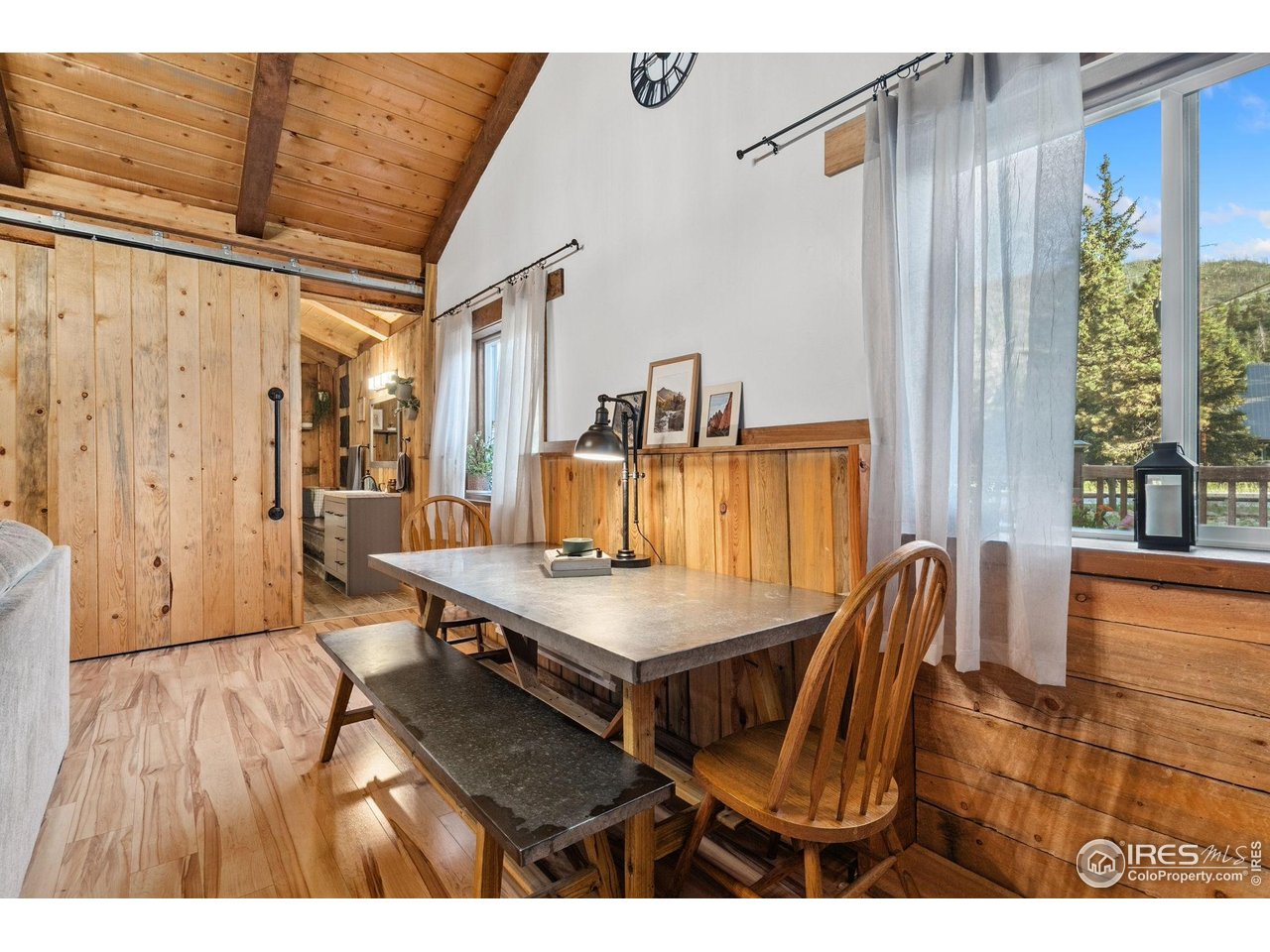 32224 Poudre Canyon Road Bellvue, CO 80512 - Photo 22 of 34 a view of a dining room with furniture and wooden floor