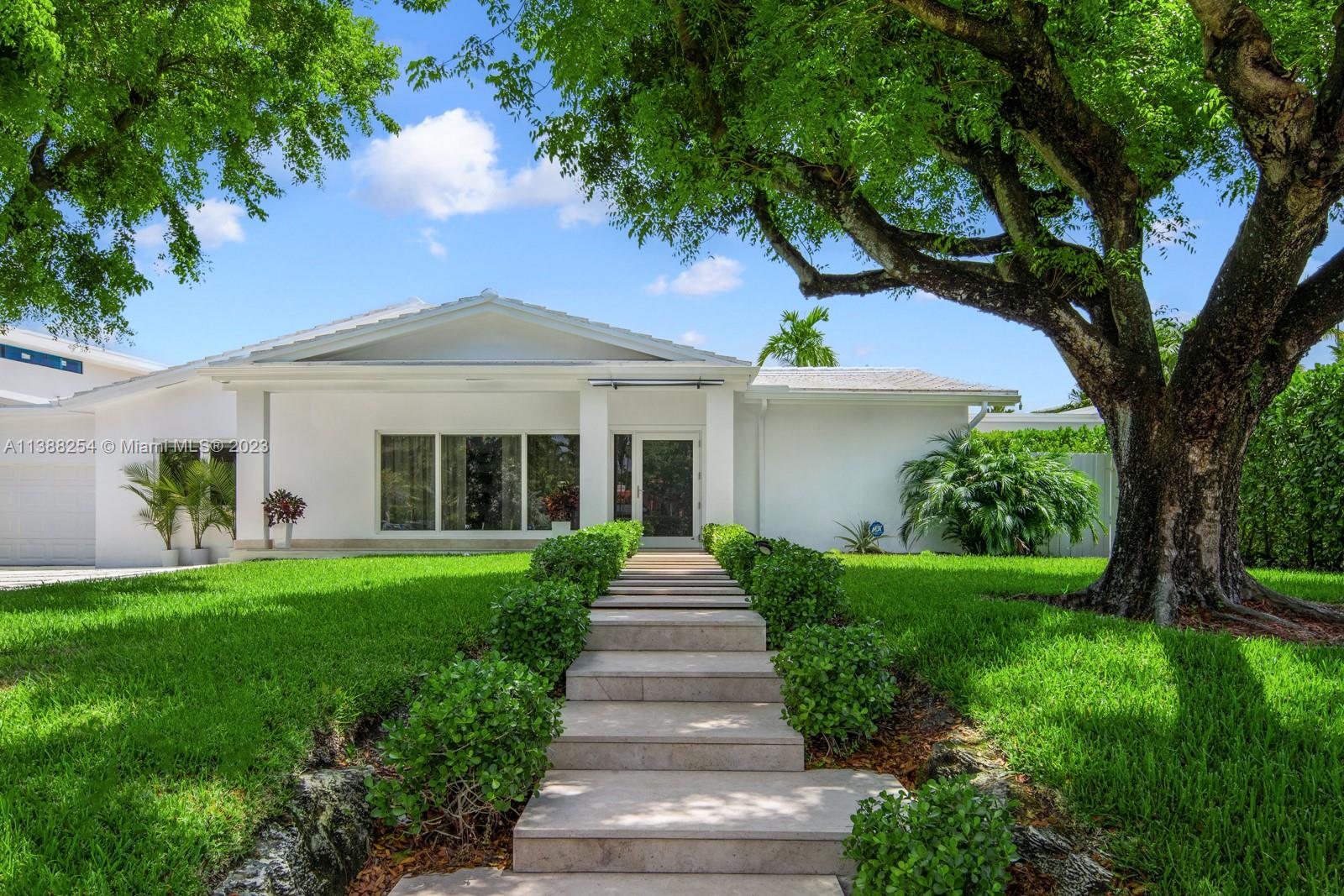 a front view of a house with a garden