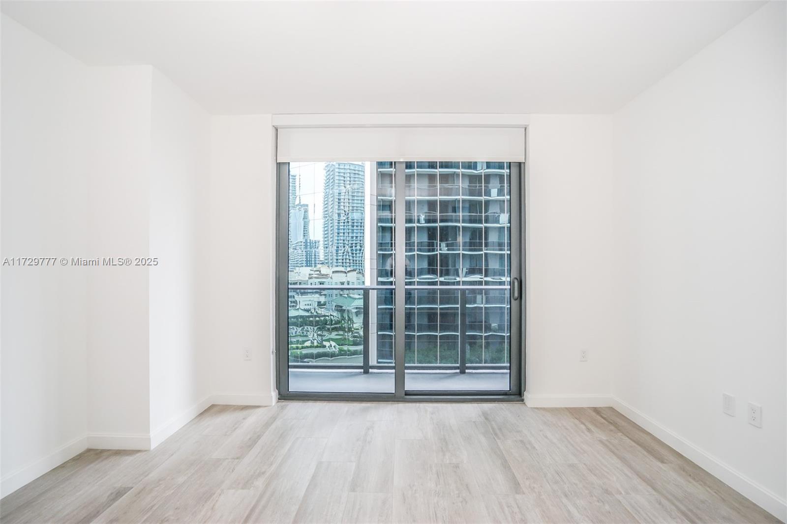 Brickell Miami, FL 33130 - Photo 6 of 24 an empty room with wooden floor and windows