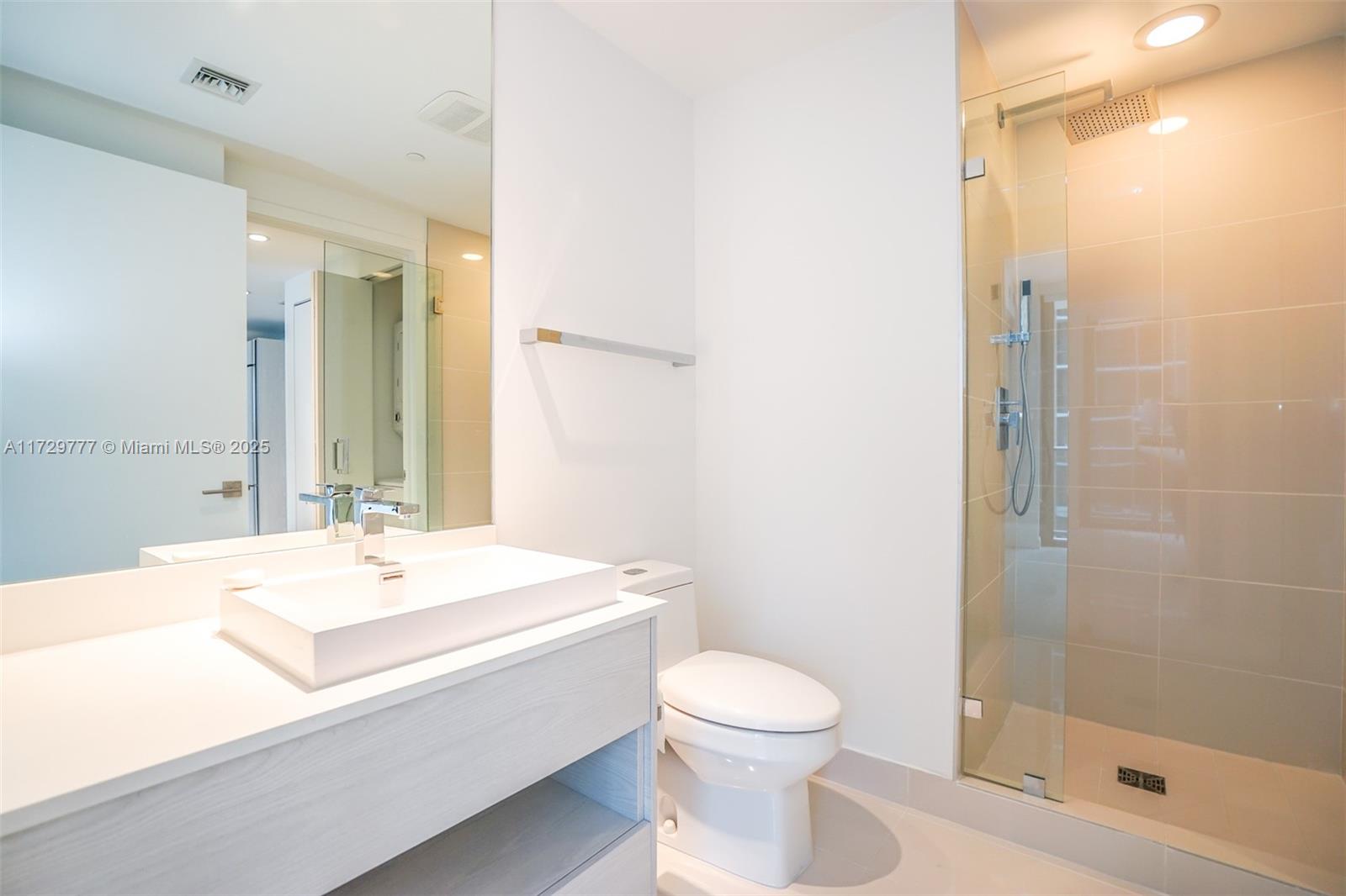 Brickell Miami, FL 33130 - Photo 9 of 24 a bathroom with a sink a toilet and shower