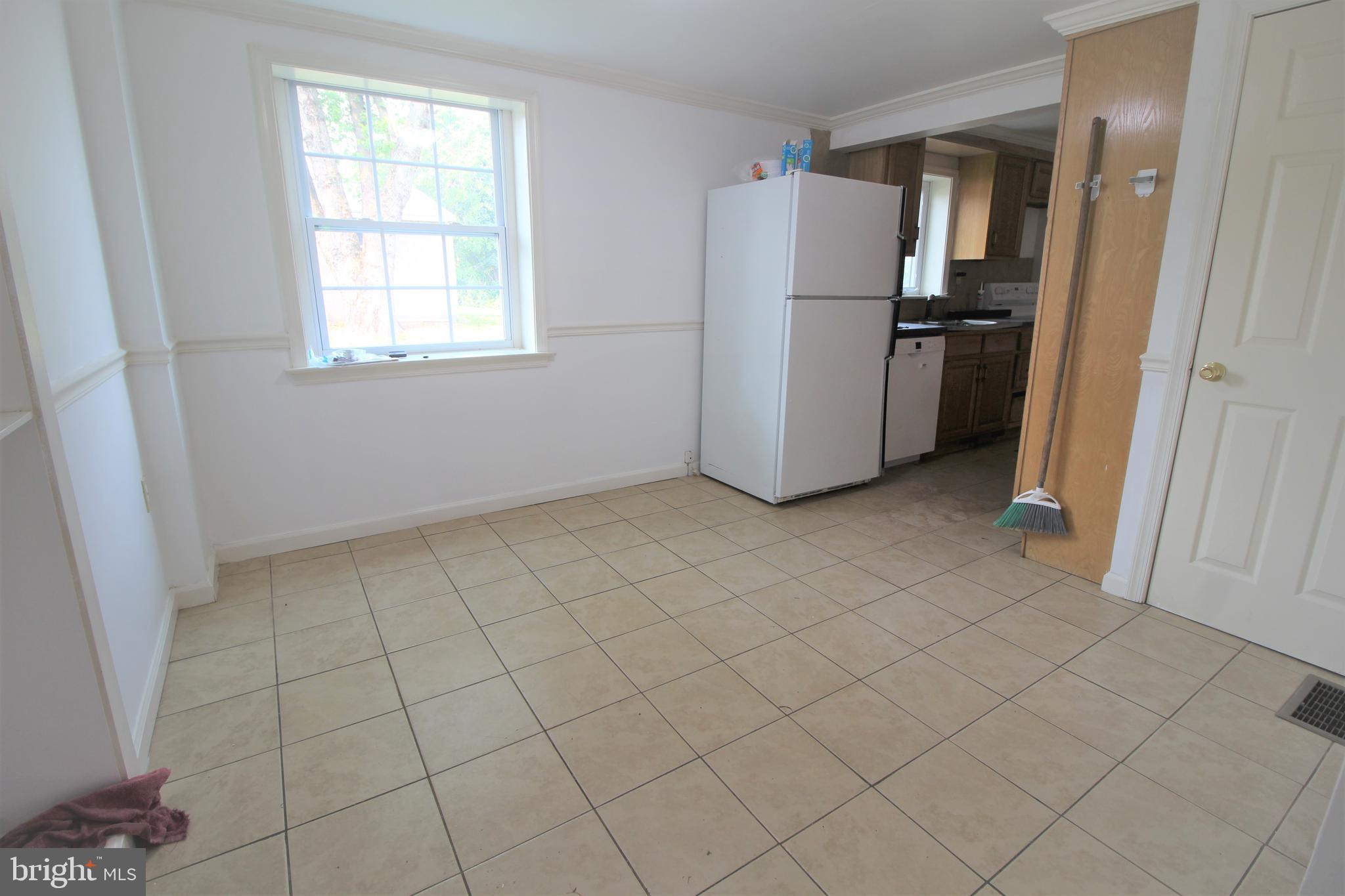 535 West Church Road Ephrata, PA 17522 - Photo 4 of 12 an empty room with a white cabinet and a refrigerator