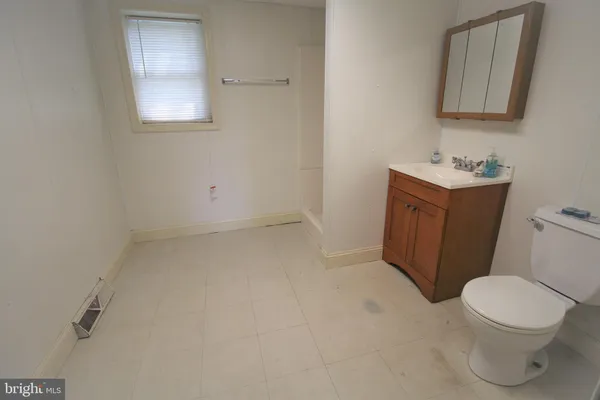 a bathroom with a sink a toilet and mirror