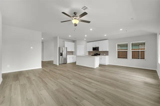 a view of a kitchen with wooden floor and a kitchen