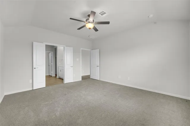 a view of a livingroom with a ceiling fan and window