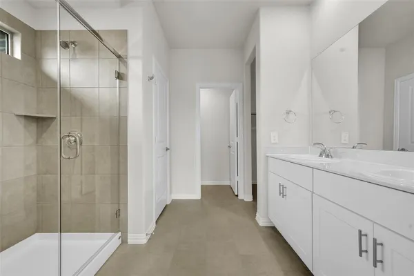 a bathroom with a shower and a sink