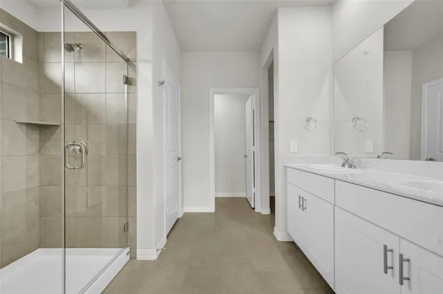 a bathroom with a shower and a sink