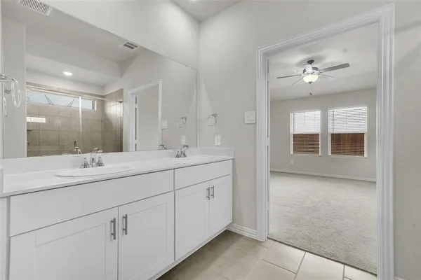 a bathroom with a double vanity sink and a mirror