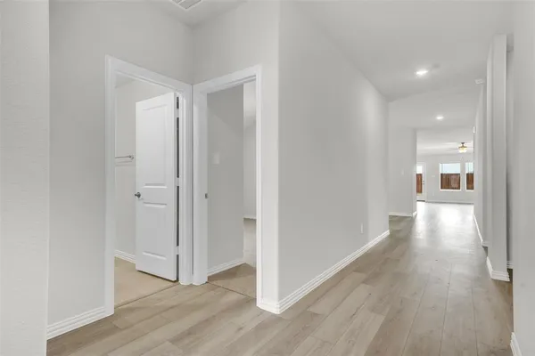 a view of a hallway with wooden floor