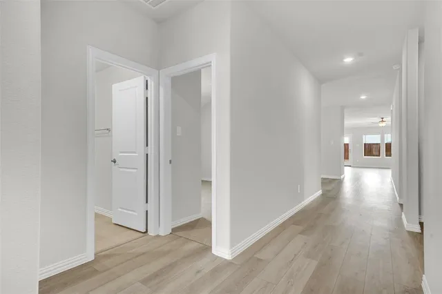 a view of a hallway with wooden floor