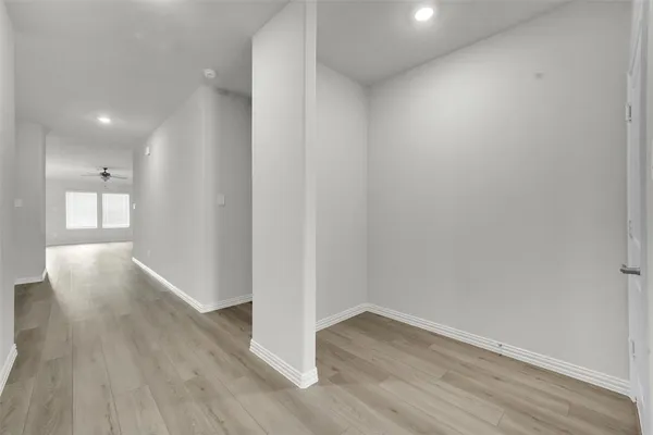 a view of a hallway with wooden floor