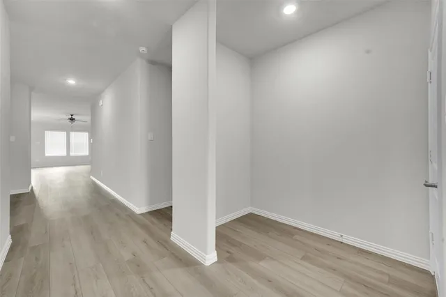 a view of a hallway with wooden floor