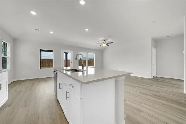 a kitchen with sink and cabinets