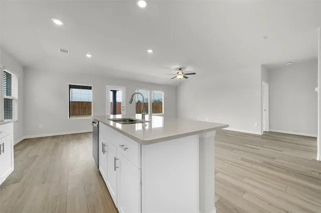 a kitchen with sink and cabinets