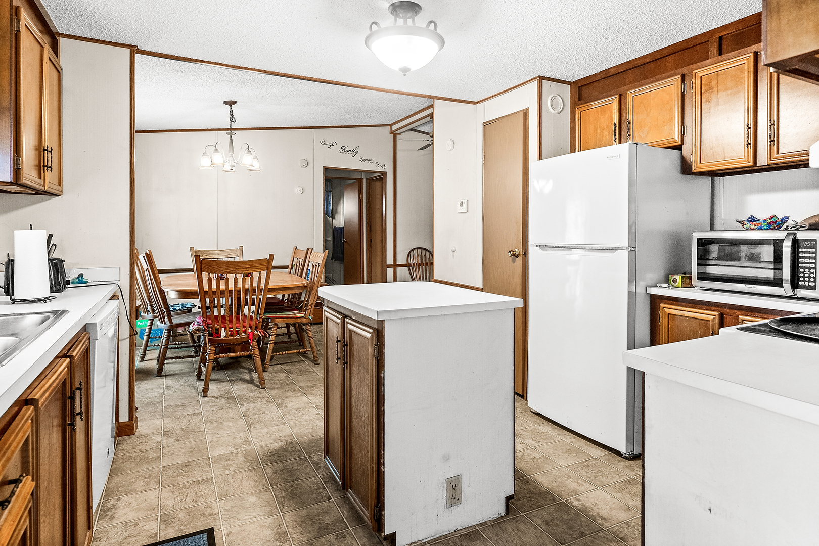 1 Christine Way Bloomington, IL 61701 - Photo 4 of 17 a kitchen with refrigerator cabinets and chairs