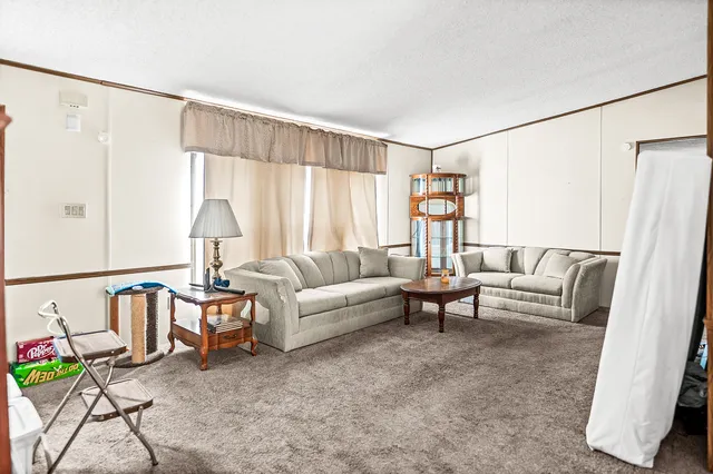 a view of a bedroom with furniture and a window