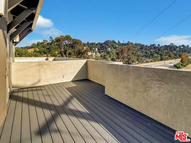 a view of balcony with wooden floor