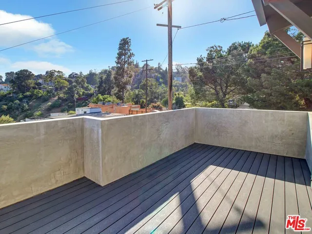 a view of a balcony with wooden floor