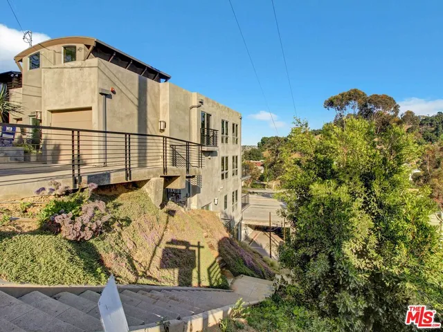 a view of a blue house with a yard
