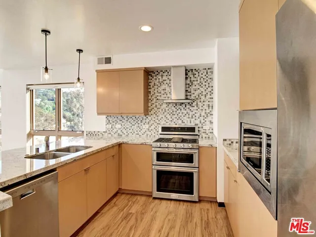 a kitchen with a sink stove and oven