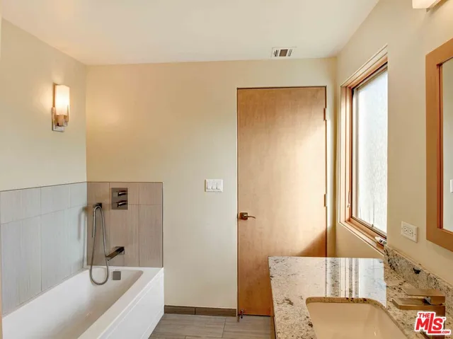 a bathroom with a tub and a window