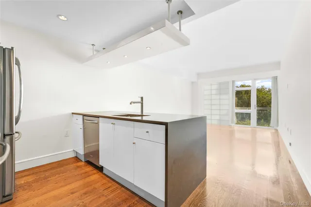 a view of a kitchen with a sink and a window