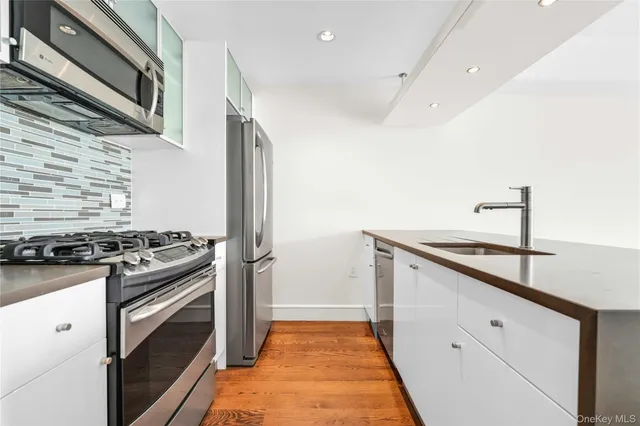 a kitchen with granite countertop stainless steel appliances and wooden cabinets
