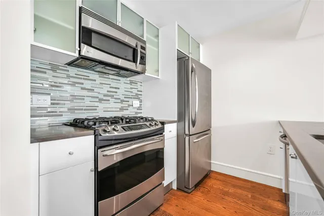 a kitchen with granite countertop wooden cabinets and stainless steel appliances