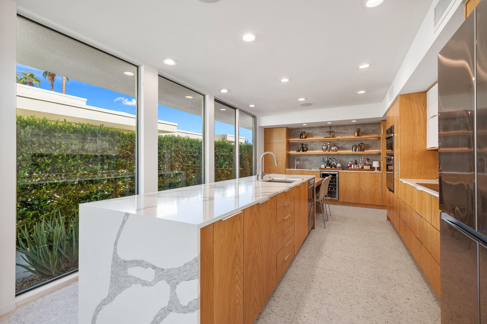 2691 Kings Road East Palm Springs, CA 92264 - Photo 14 of 45 a large kitchen with kitchen island a large window in it