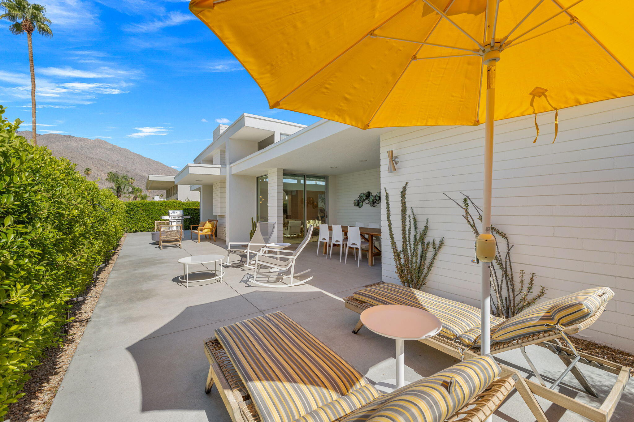 2691 Kings Road East Palm Springs, CA 92264 - Photo 33 of 45 a view of a patio with a table and chairs under an umbrella