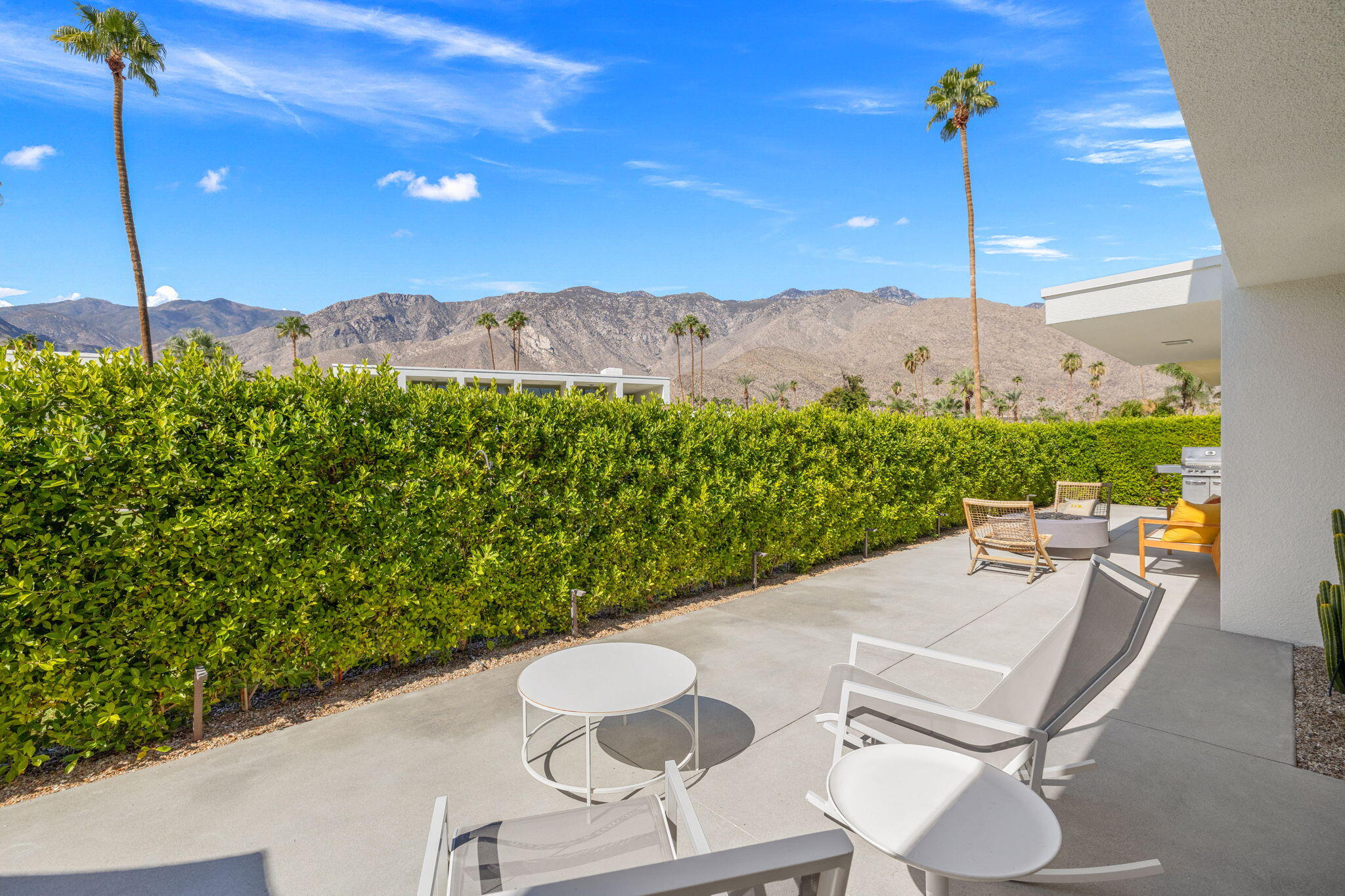 2691 Kings Road East Palm Springs, CA 92264 - Photo 35 of 45 a view of a terrace with a table and chairs