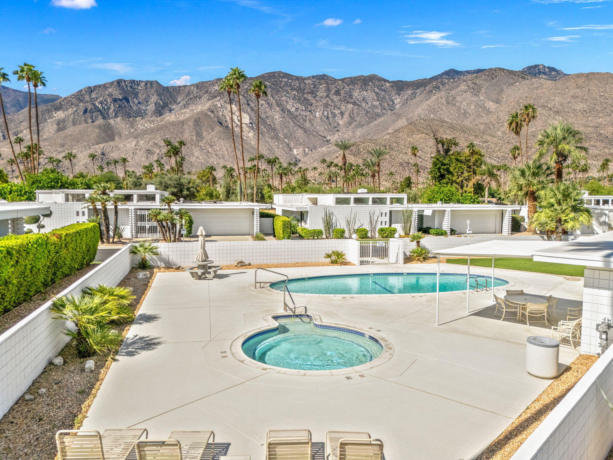 2691 Kings Road East Palm Springs, CA 92264 - Photo 44 of 45 a view of a swimming pool with a table and chairs