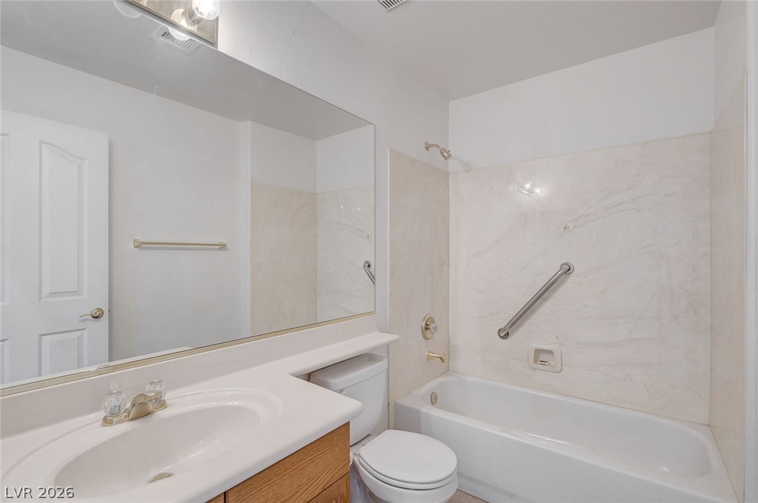1479 Orange Jubilee Road Henderson, NV 89014 - Photo 28 of 36 Functional full bathroom with an integrated vanity and full-size tub and shower combination.