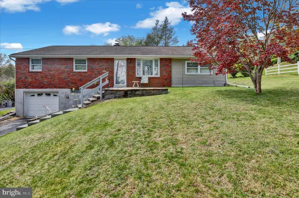 a view of a house with a backyard