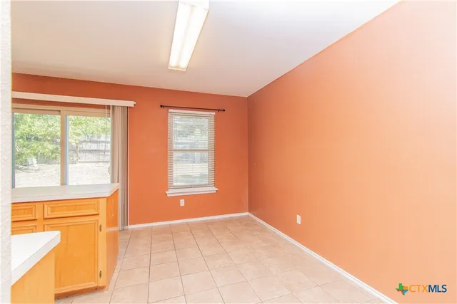 a view of an empty room and a window