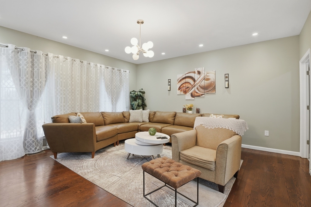 112 Pineland Avenue Worcester, MA 01604 - Photo 6 of 38 a living room with furniture and a chandelier