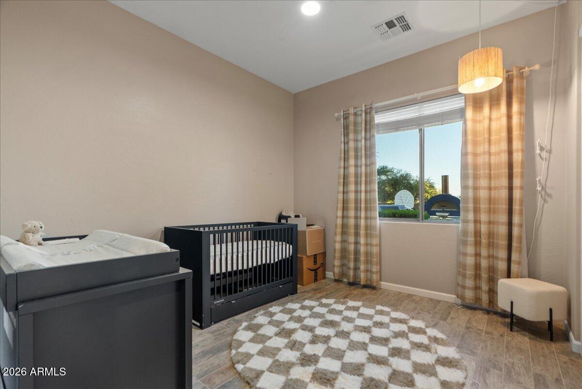 6427 South Magic Court Gilbert, AZ 85298 - Photo 16 of 71 a bedroom with a bed and a window