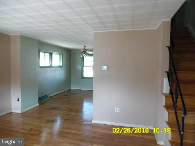 837 Lannerton Road Baltimore, MD 21220 - Photo 2 of 14 an empty room with wooden floor and windows
