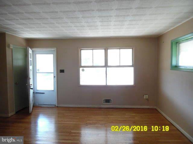 837 Lannerton Road Baltimore, MD 21220 - Photo 3 of 14 an empty room with wooden floor and windows
