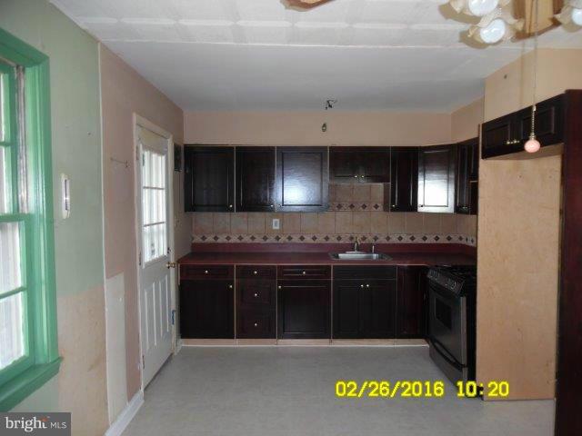 837 Lannerton Road Baltimore, MD 21220 - Photo 6 of 14 a kitchen with a sink and a refrigerator