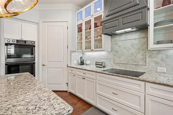 a kitchen with stainless steel appliances granite countertop a sink and a refrigerator