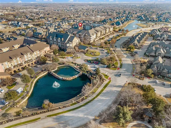 an aerial view of a house with a swimming pool and mountains