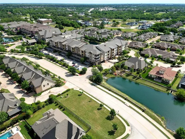 an aerial view of a residential houses with outdoor space and river